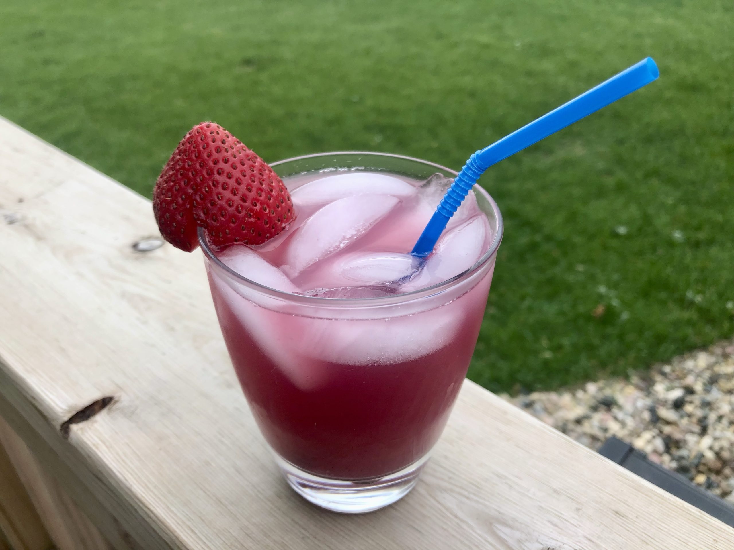 Simple Blueberry Lemonade with a strawberry