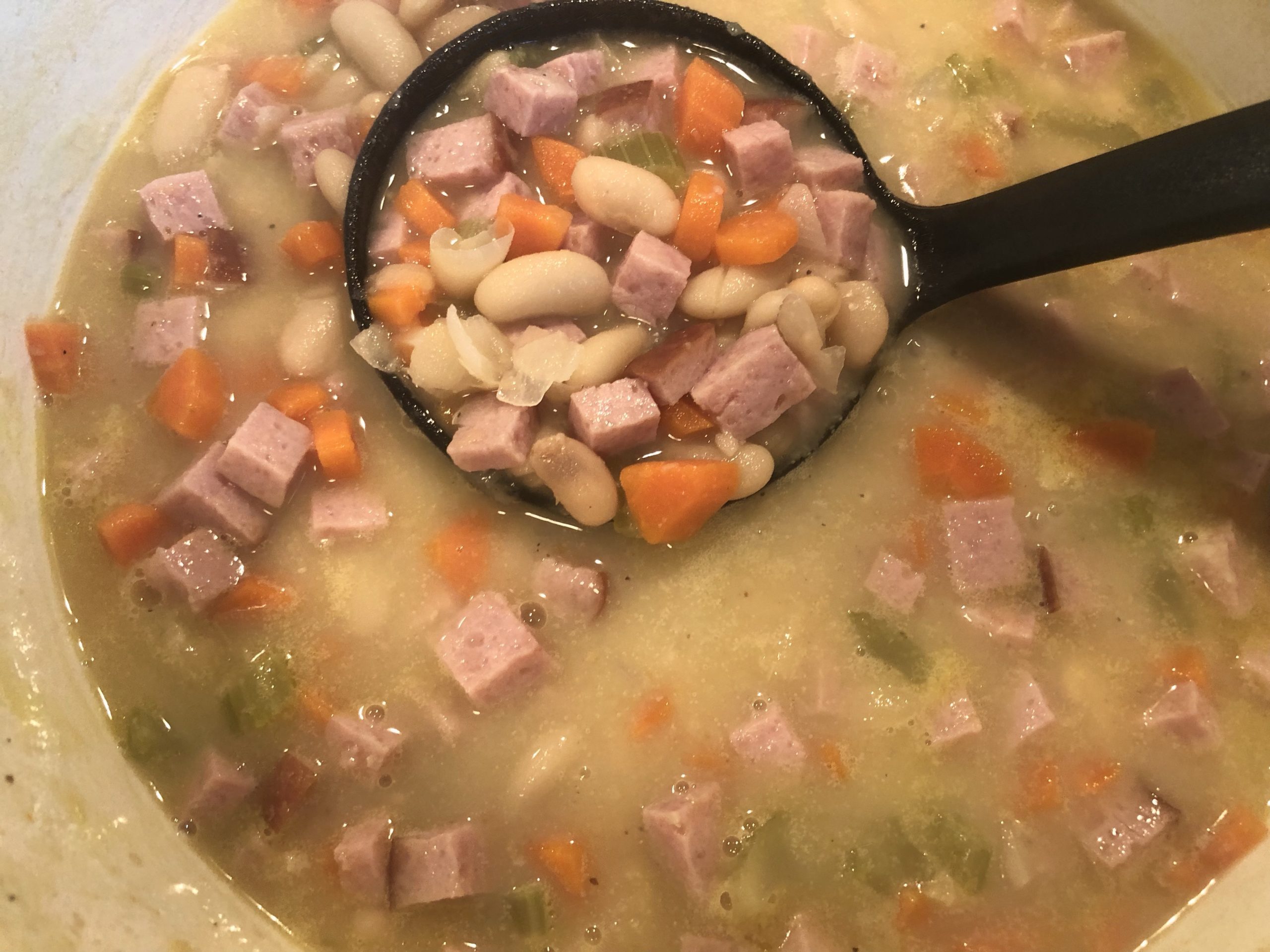 White Bean and Ham Soup with a ladle
